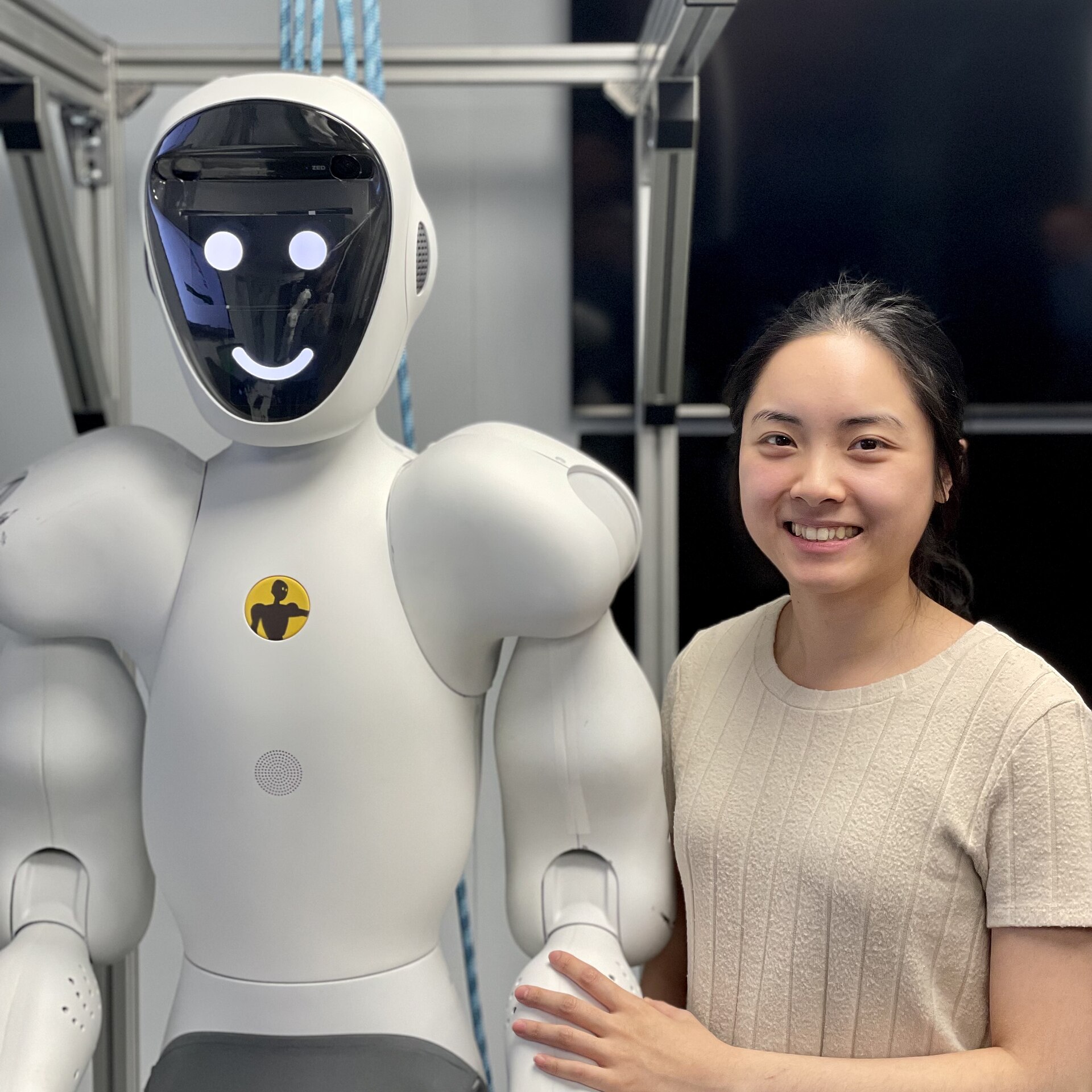 A white humanoid collaborative robot beside the engineer who trains its perception